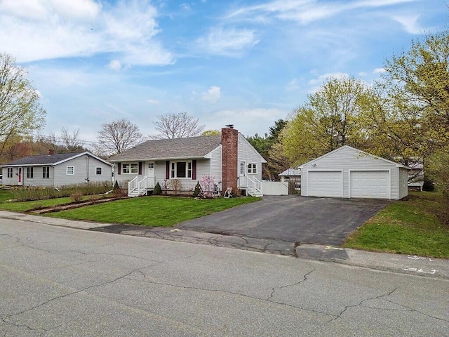 view of front of house featuring a front yard, an outdoor structure, a chimney, and a garage