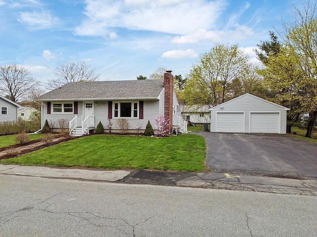 view of front of home featuring a chimney, an outbuilding, a front lawn, and a detached garage