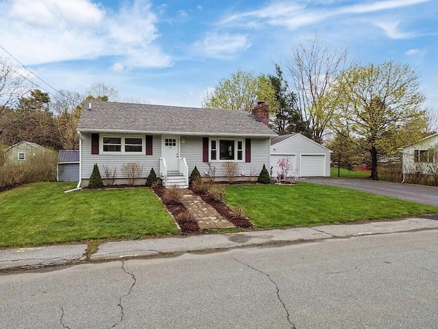 ranch-style home with a chimney, an outbuilding, a front yard, a garage, and entry steps