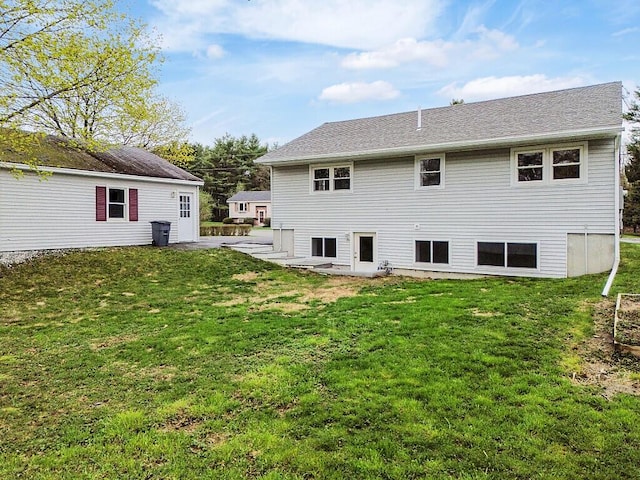 rear view of property with a yard