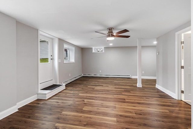 below grade area with wood finished floors, a ceiling fan, baseboards, baseboard heating, and a baseboard radiator