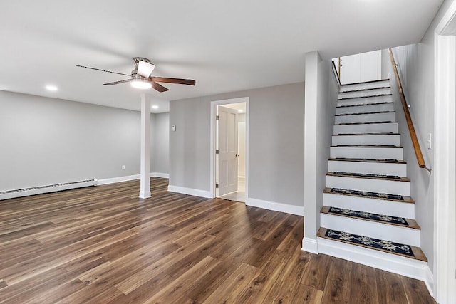 basement with stairs, wood finished floors, a ceiling fan, baseboard heating, and baseboards