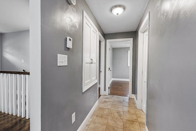 hallway featuring baseboards