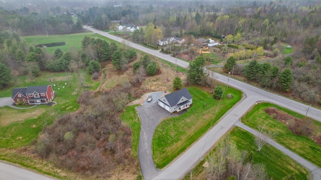 aerial view of property's location featuring rural landscape and a forest