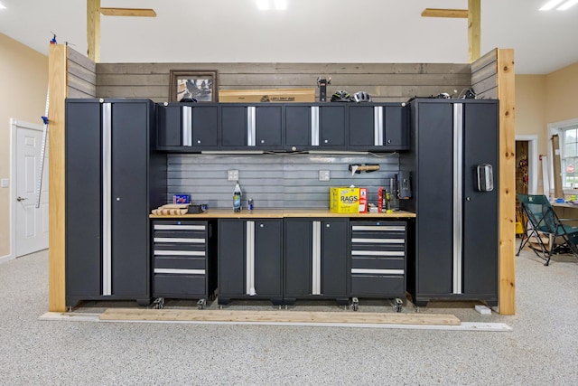 kitchen featuring light countertops and dark aggregate flooring