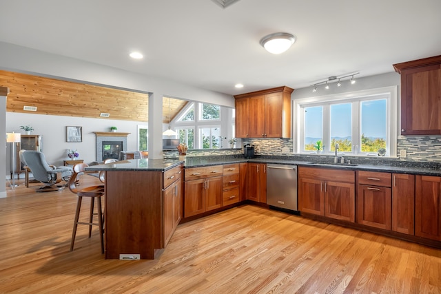48 White Mountain Way, Bridgton, ME 04009 - kitchen featuring dishwasher, a sink, a peninsula, light wood-style floors, and open floor plan