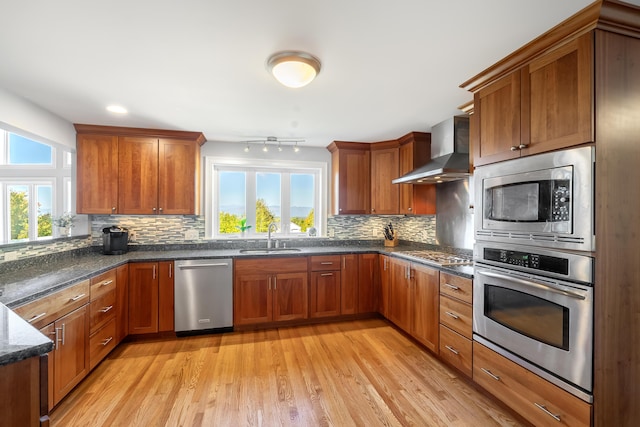 48 White Mountain Way, Bridgton, ME 04009 - kitchen featuring appliances with stainless steel finishes, wall chimney exhaust hood, a sink, and plenty of natural light