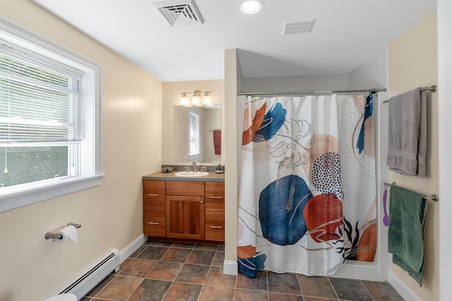 48 White Mountain Way, Bridgton, ME 04009 - bathroom with a baseboard heating unit, baseboards, plenty of natural light, and vanity