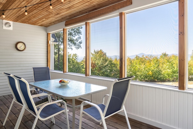 48 White Mountain Way, Bridgton, ME 04009 - sunroom / solarium with rail lighting, a mountain view, and outdoor dining space
