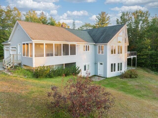 48 White Mountain Way, Bridgton, ME 04009 - back of property with a sunroom and a yard