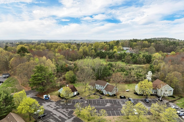 birds eye view of property featuring a wooded view