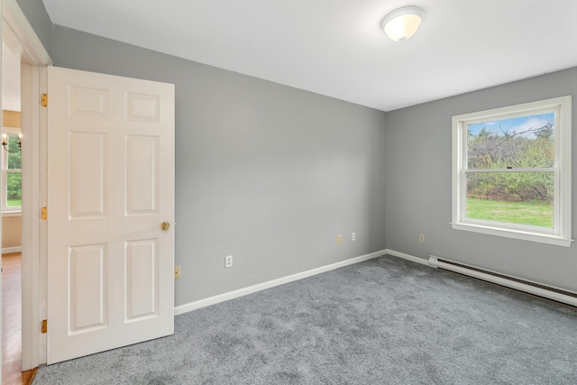 carpeted empty room featuring baseboards and baseboard heating