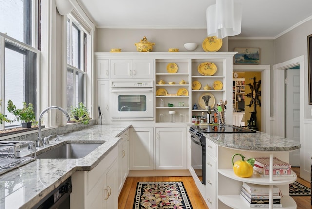94 Neal St Unit 2N, Portland, ME 04102 - kitchen featuring open shelves, oven, light wood-style floors, range with electric cooktop, and ornamental molding