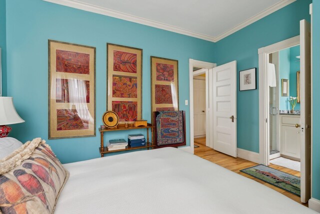 94 Neal St Unit 2N, Portland, ME 04102 - bedroom with wood finished floors, ornamental molding, and ensuite bath