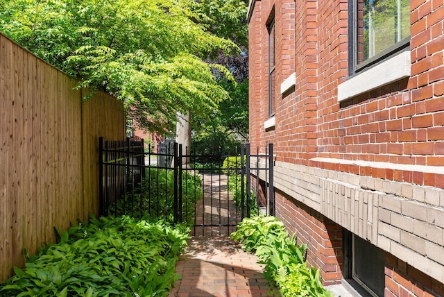94 Neal St Unit 2N, Portland, ME 04102 - view of home's exterior with brick siding and a gate