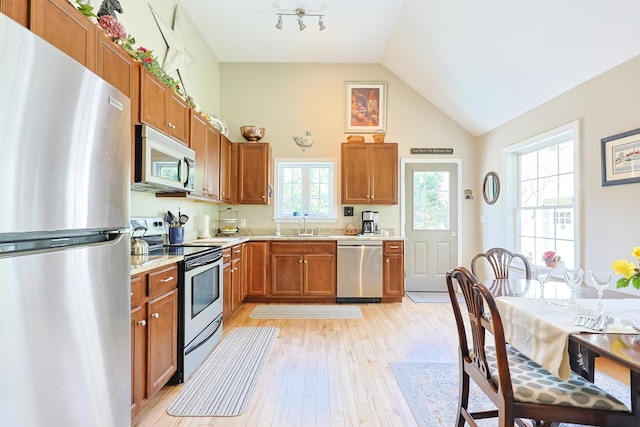 8 Codys Way, Bridgton, ME 04009 - kitchen with appliances with stainless steel finishes, light countertops, brown cabinetry, light wood-style flooring, and plenty of natural light