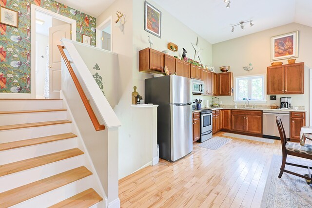 8 Codys Way, Bridgton, ME 04009 - kitchen with appliances with stainless steel finishes, brown cabinets, light countertops, light wood-style flooring, and vaulted ceiling