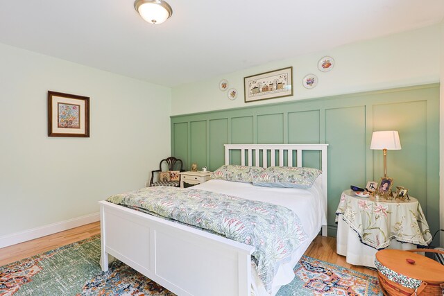 8 Codys Way, Bridgton, ME 04009 - bedroom with light wood finished floors, a decorative wall, and wainscoting