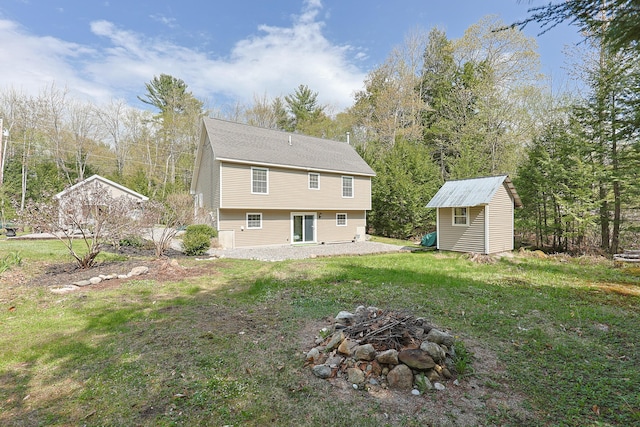8 Codys Way, Bridgton, ME 04009 - rear view of house with a fire pit and a lawn