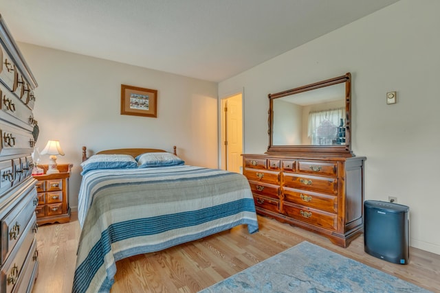 bedroom featuring wood finished floors and baseboards