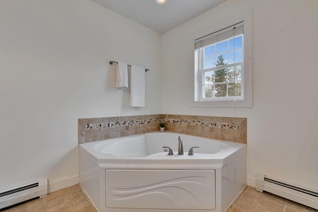 full bathroom with baseboard heating, a bath, baseboards, and tile patterned floors