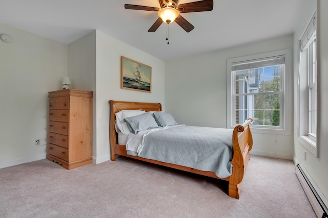 bedroom with a baseboard radiator, light carpet, baseboards, and a ceiling fan