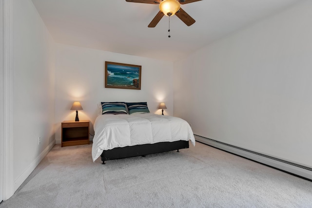 carpeted bedroom featuring a baseboard heating unit, ceiling fan, and baseboards