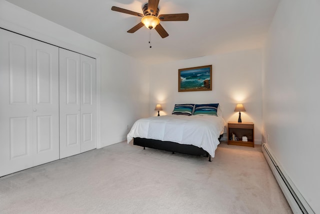 bedroom with a baseboard radiator, light carpet, a closet, and baseboards