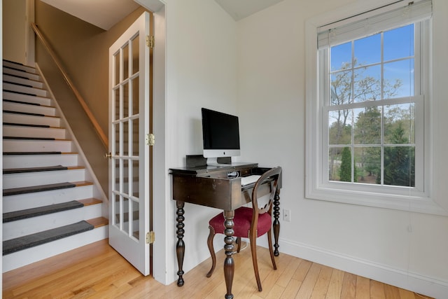 office area featuring baseboards and wood finished floors