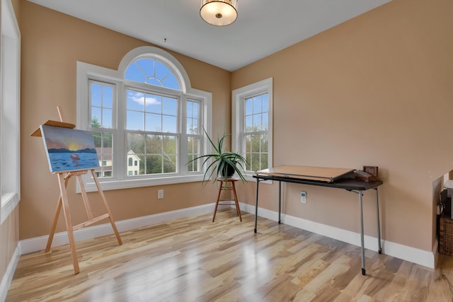 misc room featuring wood finished floors and baseboards