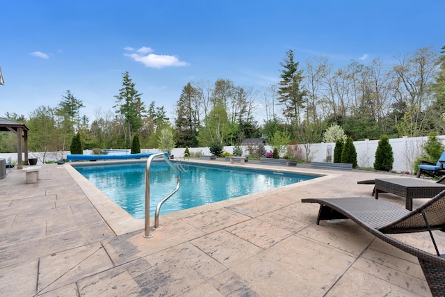 view of swimming pool with a patio, a fenced backyard, and a gazebo