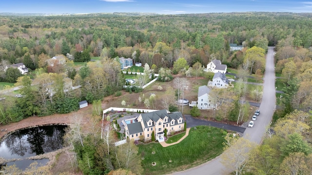 view of property location featuring a forest