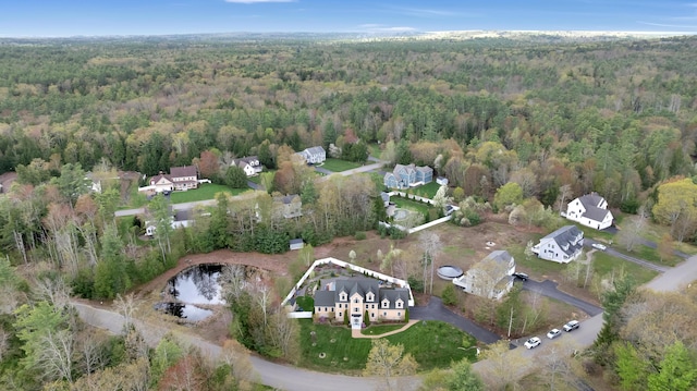 aerial view of property's location featuring a forest