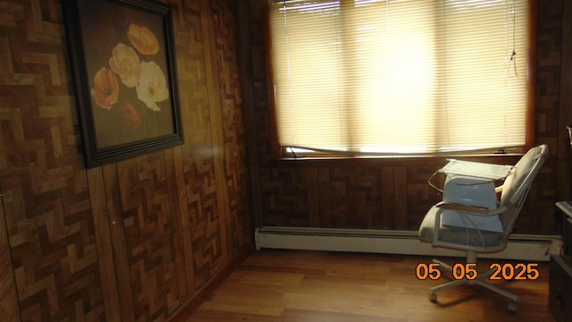 20 Morgan St, Lincoln, ME 04457 - sitting room with a baseboard radiator, wood walls, and wood finished floors