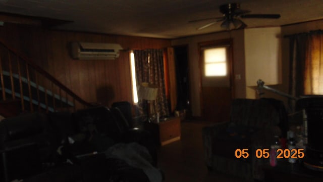 20 Morgan St, Lincoln, ME 04457 - living area featuring stairs, a wall unit AC, a ceiling fan, and wooden walls