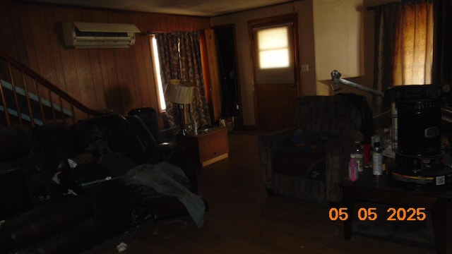 20 Morgan St, Lincoln, ME 04457 - living room with wooden walls, an AC wall unit, stairs, and wood finished floors