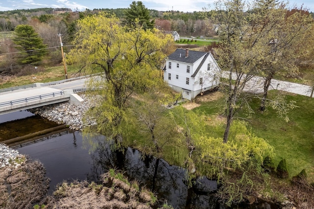 aerial view of property and surrounding area featuring a large body of water