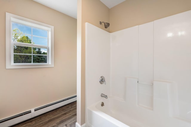 bathroom with baseboard heating, wood finished floors, and  shower combination
