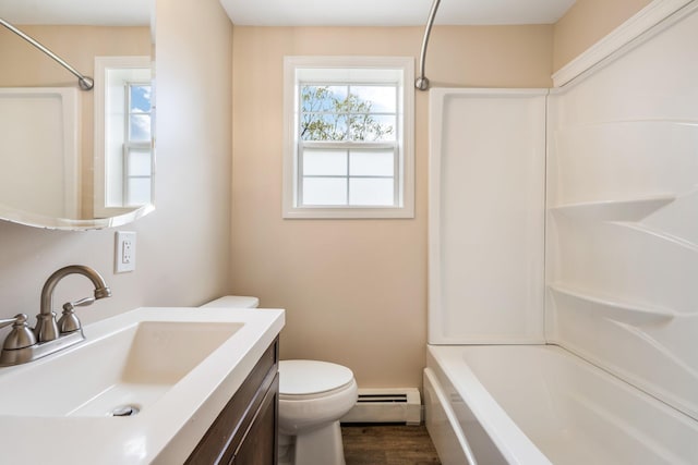 bathroom featuring a baseboard radiator, toilet, vanity, wood finished floors, and shower / bathtub combination