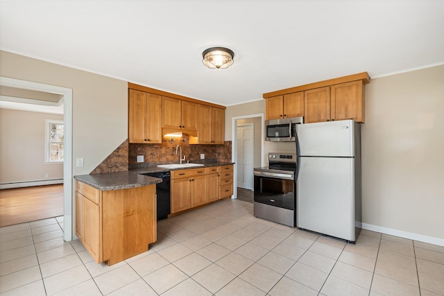 kitchen with stainless steel appliances, a sink, dark countertops, tasteful backsplash, and ornamental molding