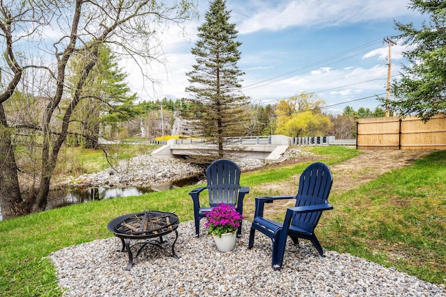 view of yard featuring a fire pit and fence
