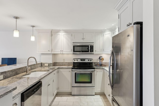 709 Chandlers Wharf Unit 709, Portland, ME 04101 - kitchen featuring stainless steel appliances, a sink, light stone counters, white cabinets, and pendant lighting