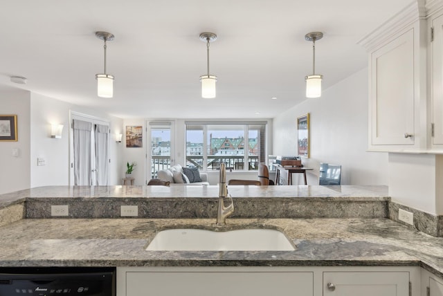 709 Chandlers Wharf Unit 709, Portland, ME 04101 - kitchen featuring a sink, black dishwasher, white cabinetry, decorative light fixtures, and dark stone counters
