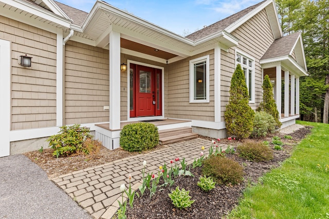 property entrance featuring roof with shingles