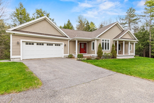 view of front of property featuring covered porch, an attached garage, driveway, a front lawn, and a shingled roof