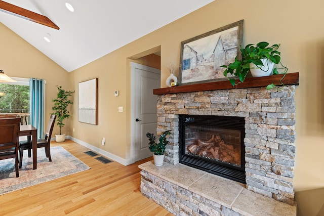 living area featuring high vaulted ceiling, recessed lighting, a fireplace, baseboards, and light wood-style floors