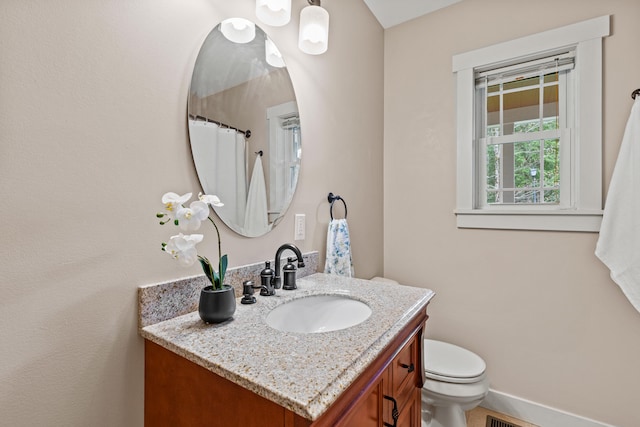 full bath with toilet, baseboards, and vanity