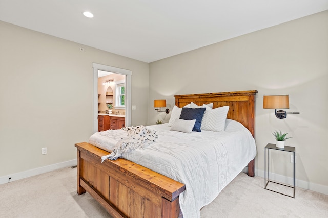 bedroom with light carpet, connected bathroom, baseboards, and recessed lighting