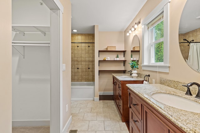 bathroom featuring a sink, two vanities, baseboards, and shower / bath combination with curtain