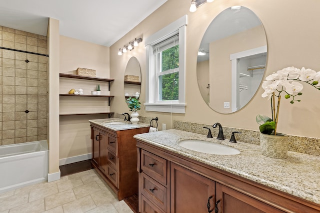 full bathroom featuring shower / bath combination, tile patterned floors, two vanities, and a sink